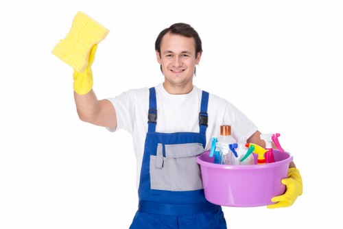 Cleaner working on accessible windows, frames, and sills in Bayswater