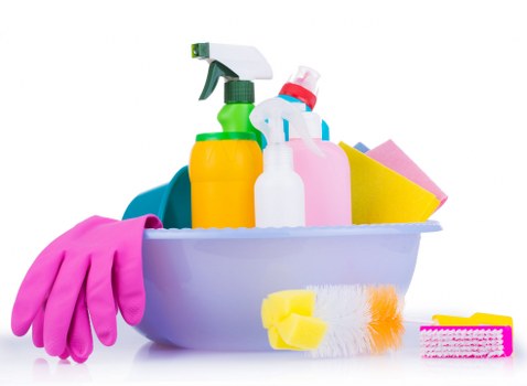 Office cleaner sanitising washroom facilities in a Bayswater business