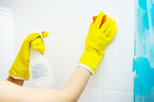 Technician treating stains on a lounge sofa in Bayswater